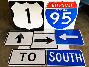 A picture showing a collection of interstate signsn and directional arrows