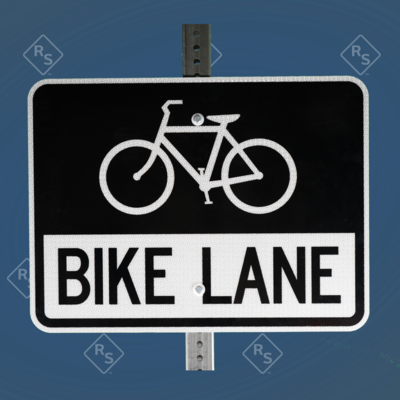 A 360 degree view of a black and white sign that has the words Bike Lane in large black text with a bike symbol on top