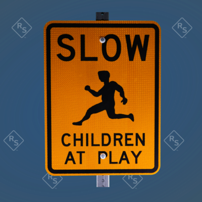 A 360 degree view of a yellow and black sign that has the word slow on top and a symbol of a child with the lower text saying Children At Play