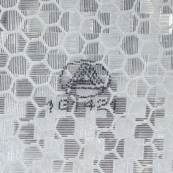 Close-up of Avery Dennison T-11500 OmniCube full-cube prismatic reflective sheeting texture, white