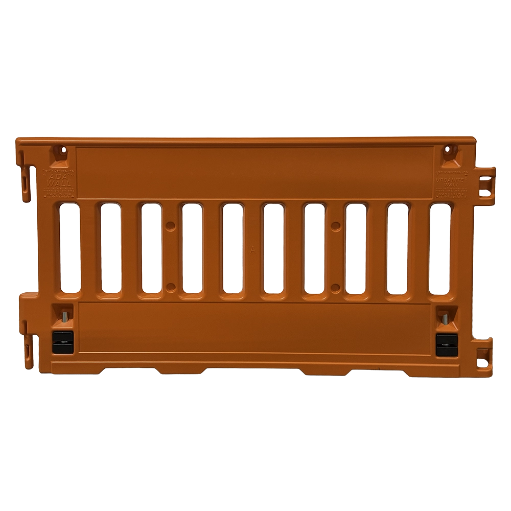 This orange plastic TrafFix ADA Wall pedestrian barricade features a solid upper rail, a slatted open middle section with vertical slats for visibility, and a solid lower panel. Interlocking hook-and-loop connectors on each end allow multiple units to be linked together. Two foldable metal support legs with black rubber feet are shown in the stored position. Molded branding reads ADA Wall and Urbanite Wall with Made in USA markings.