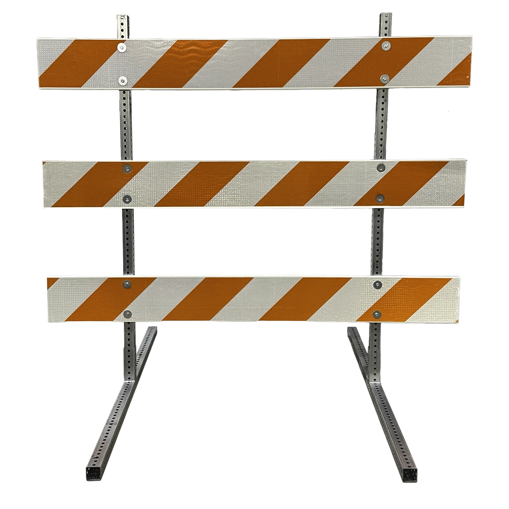A product photograph of a Type III traffic barricade with galvanized steel perforated angle-iron uprights and angled steel base legs, featuring three horizontal rails with orange-and-white diagonal high intensity prismatic reflective sheeting for superior nighttime retroreflectivity. Classified under MUTCD Part 6K, this heavy-duty steel construction provides greater durability and stability compared to plastic-base models, making it ideal for long-term road closures, highway construction, and high-speed roadway applications.