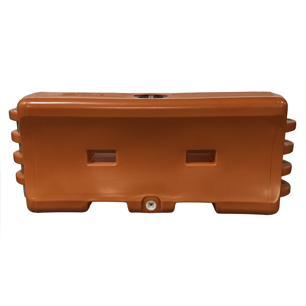 An orange plastic water-fillable traffic barrier (water wall) with a rectangular low-profile design, featuring two recessed hand-grip slots on the front face, a fill port on the top, and metal connecting pins on each end for linking multiple units together.