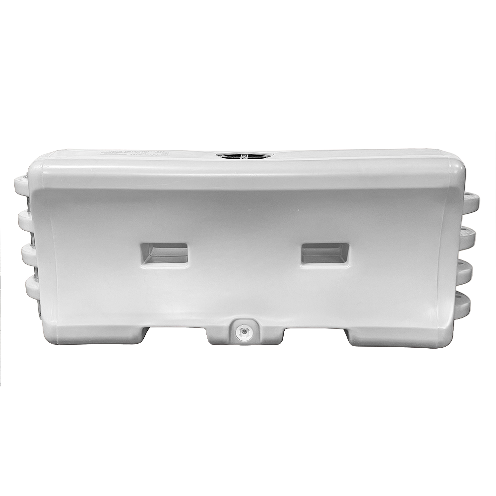 This white plastic water-filled traffic barrier features a rectangular, low-profile design built for ballast stability when filled with water. The front face includes two recessed hand-grip slots for easier handling. A black twist-to-lock fill cap is centered on top for water filling, and a white drain plug is located near the bottom. Interlocking flanges with connection pin holes on each end allow multiple units to be linked together