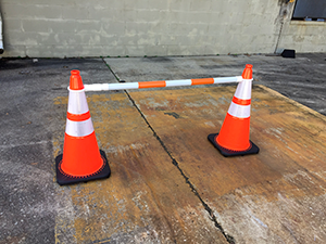 A large stack of custom traffic cones that is ready for shipment