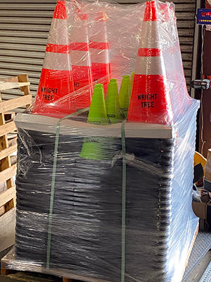 A large stack of custom traffic cones that is ready for shipment
