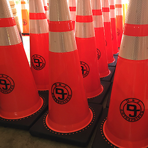 A picture of many orange custom traffic cones