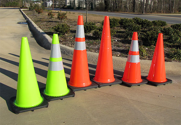 A line up of six different cones that are either 28 inches tall or 36 inches tall.  Both green and orange colors are shown.