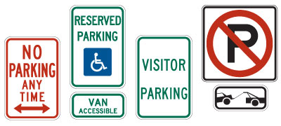 A picture of a no parking any time sign, reserved parking handicapped, visitor parking, and tow away signs