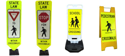 A picture of several in street pedestrian signs