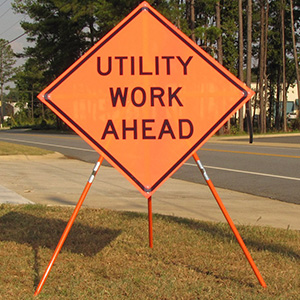 This photo shows a mesh roll up sign with a tripod stand