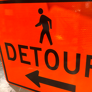 Picture of pedestrian detour sign with a left arrow