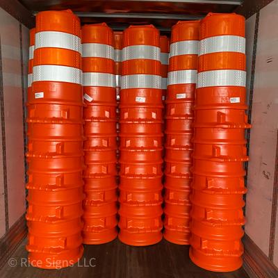 Traffic drums being unloaded from a truck