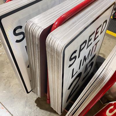 A cart with finished speed limit signs