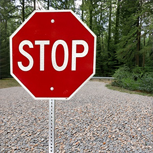 This photo show a stop sign in an outdoor setting.