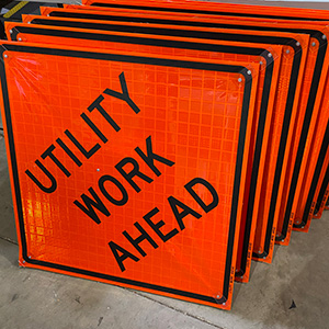 Picture of a stack of Utility Work Ahead roll up signs