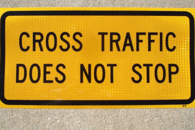 Up-close photo of our Cross Traffic Does Not Stop sign