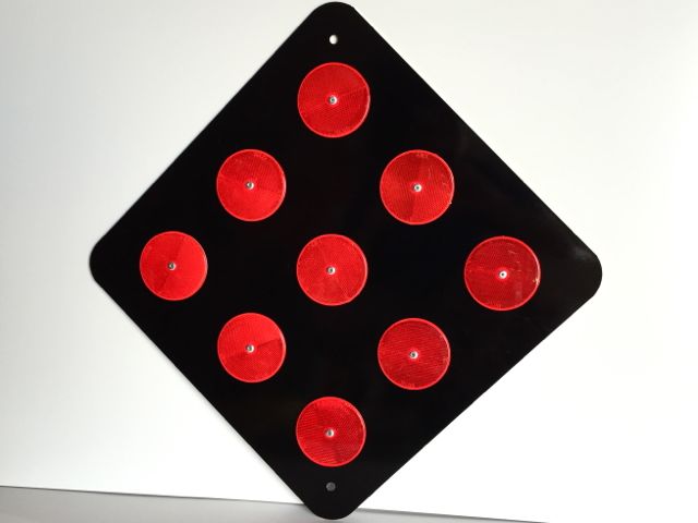 Actual picture of our OM4-2 end of road marker with red reflectors on a black background.