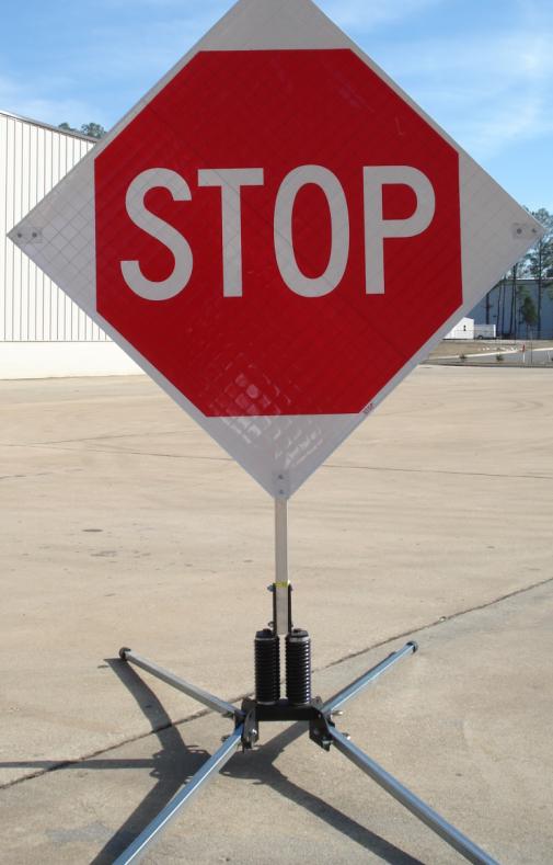 The roll-up stop sign is shown with a portable RU5000 wind resistant sign stand (sold separately).