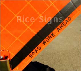 Velcro can be applied around the word AHEAD on our Road Work Ahead roll-up sign. This permits roll-up overlays with different messages to be used to easily change the distance. For example: with the 1000 FT overlay, you could change the message of the sign to Road Work 1000 Ft. This sign features screen printed text in the border, so that when it is rolled up you can see ROAD WORK AHEAD printed in the margin for easy identification. 