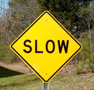 Pictured: A Slow street sign is shown on an optional u-channel highway post.