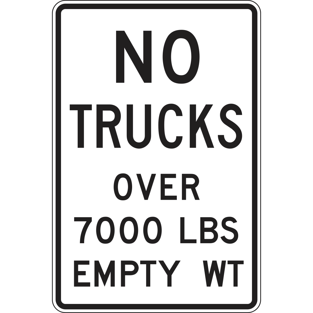 The R12-3 is a vertical rectangular regulatory sign with rounded corners, featuring a white background, black text, and a black border. The sign displays the legend NO TRUCKS in large bold lettering at the top, followed by OVER 7000 LBS EMPTY WT in slightly smaller black text below. There are no symbols or pictographs on the sign; it relies entirely on its text-based message to communicate the truck empty weight restriction to drivers.