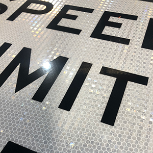 This up close image of a speed limit sign shows the reflective sheeting.  HIP sheeting meets the minimum state requirements.  