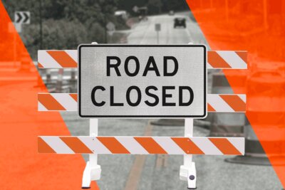 A Road closed sign that has been installed on a type 3 barricade